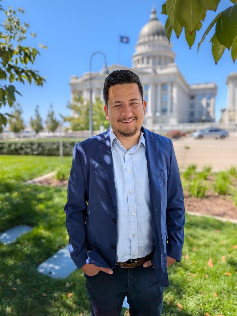 Mosiah Olvera standing on the lawn in front of a domed capitol building